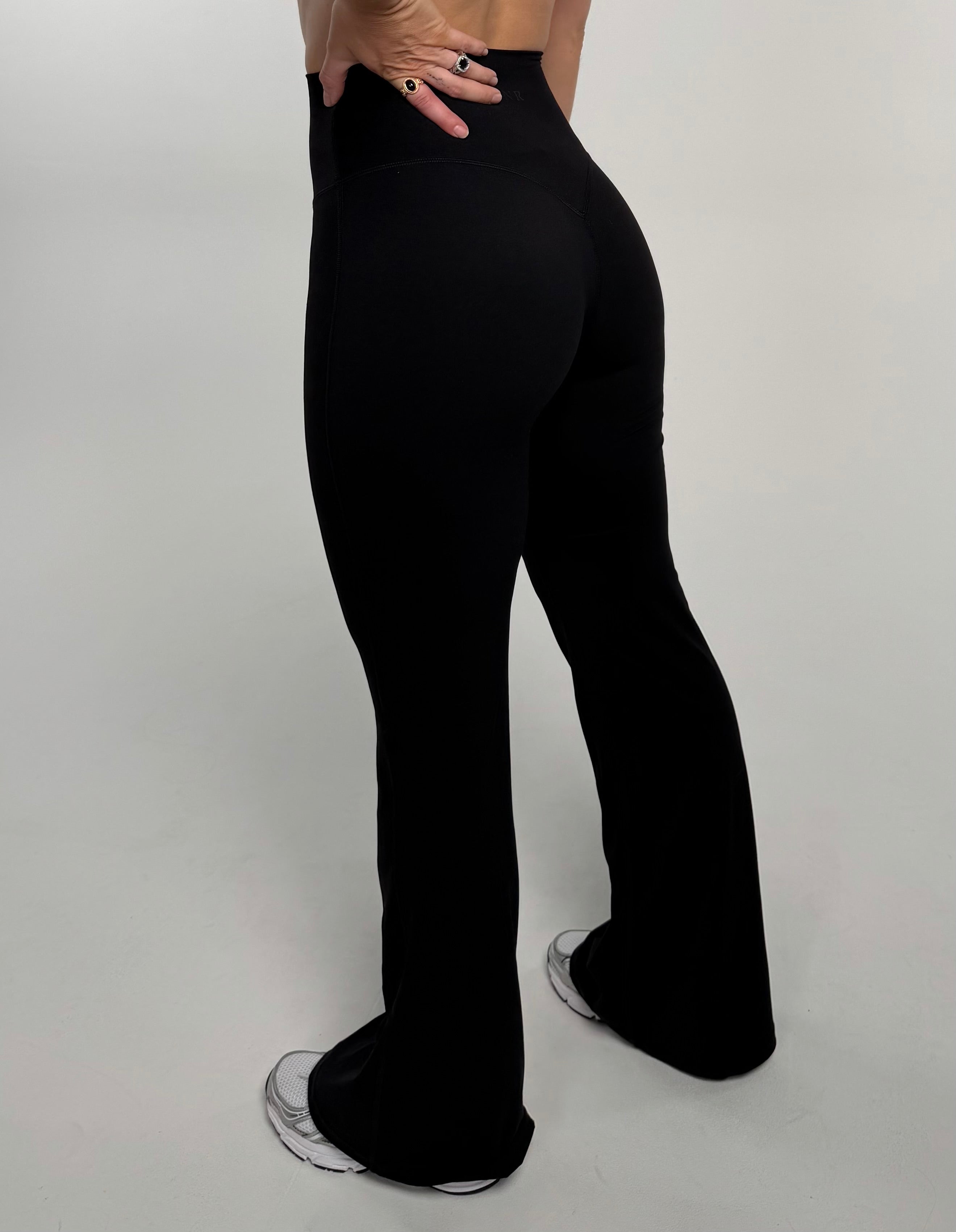 Back view of active girl wearing the Noa Flare Tight. In 4 way stretch fabric.