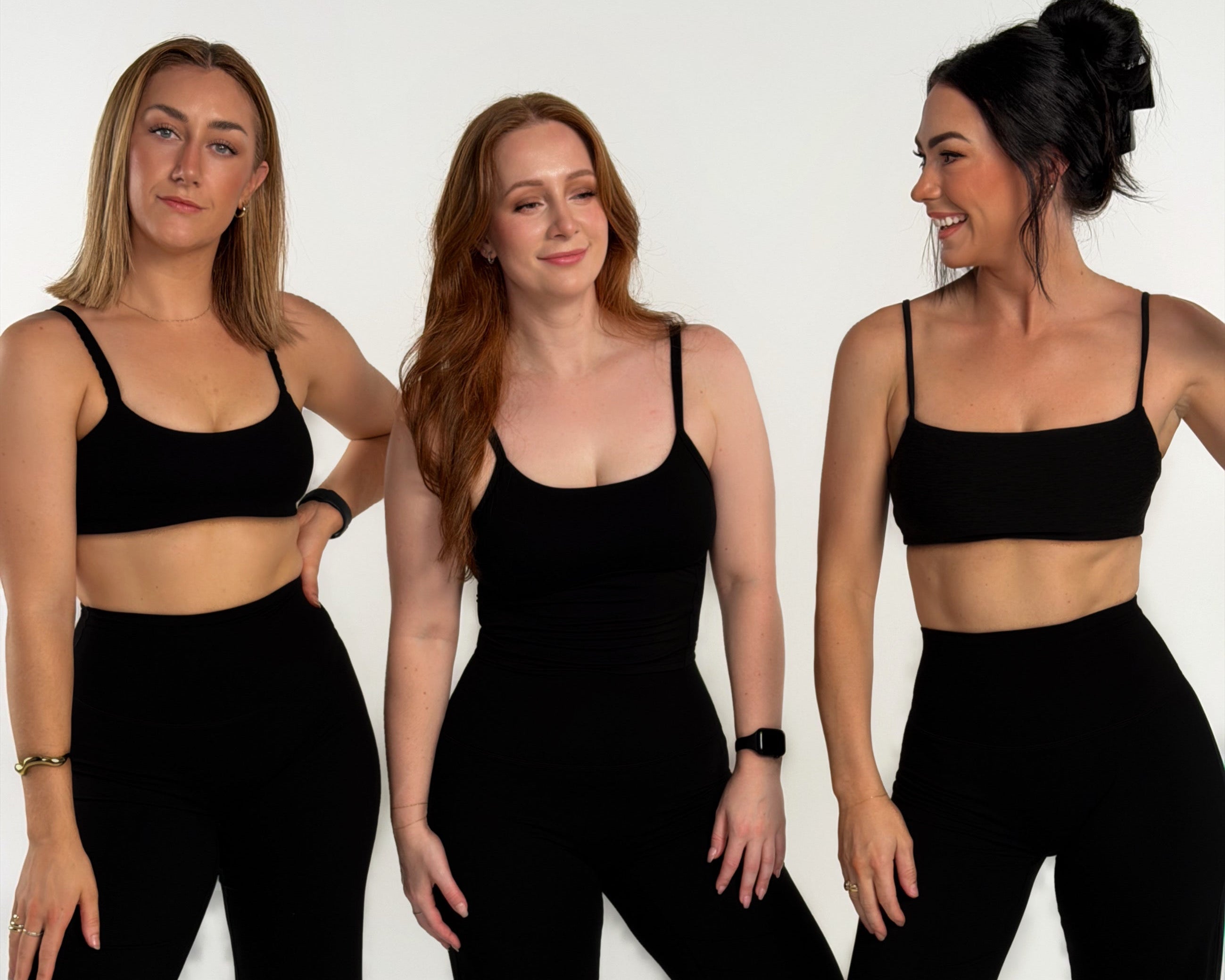 Three women wearing black athletic wear posing against a white background
